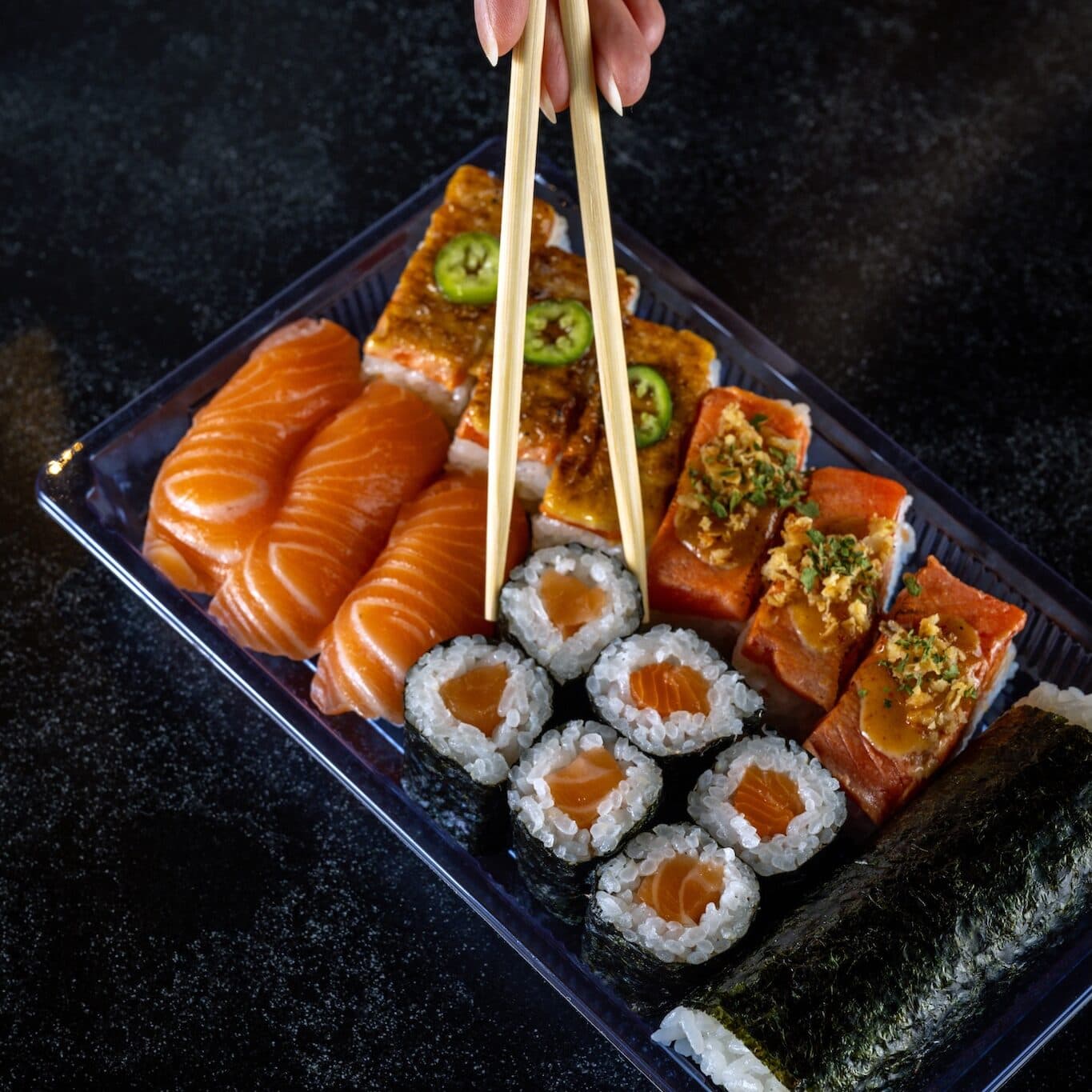 A takeout combo of four types of salmon sushi.