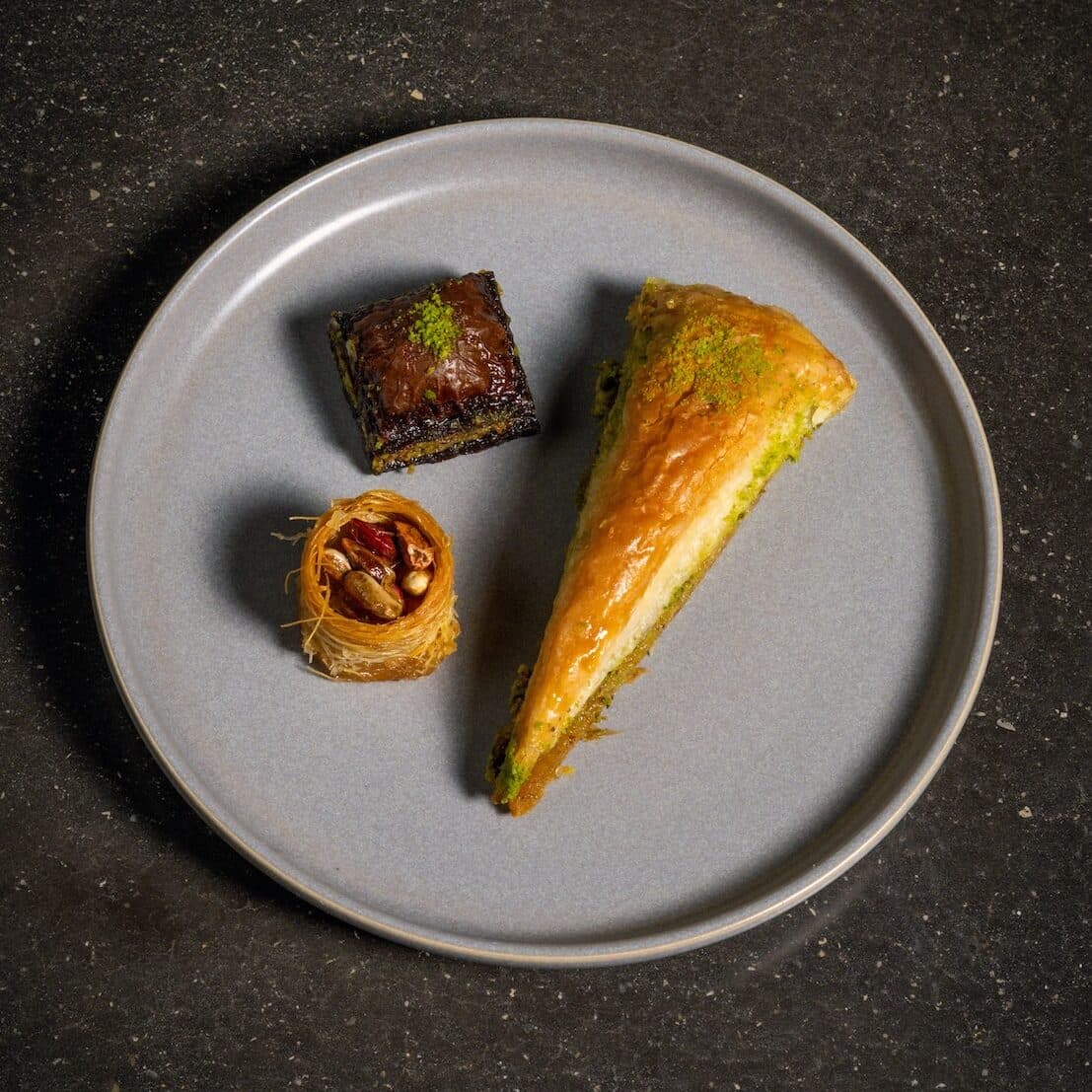 A plate of three Turkish Baklava desserts