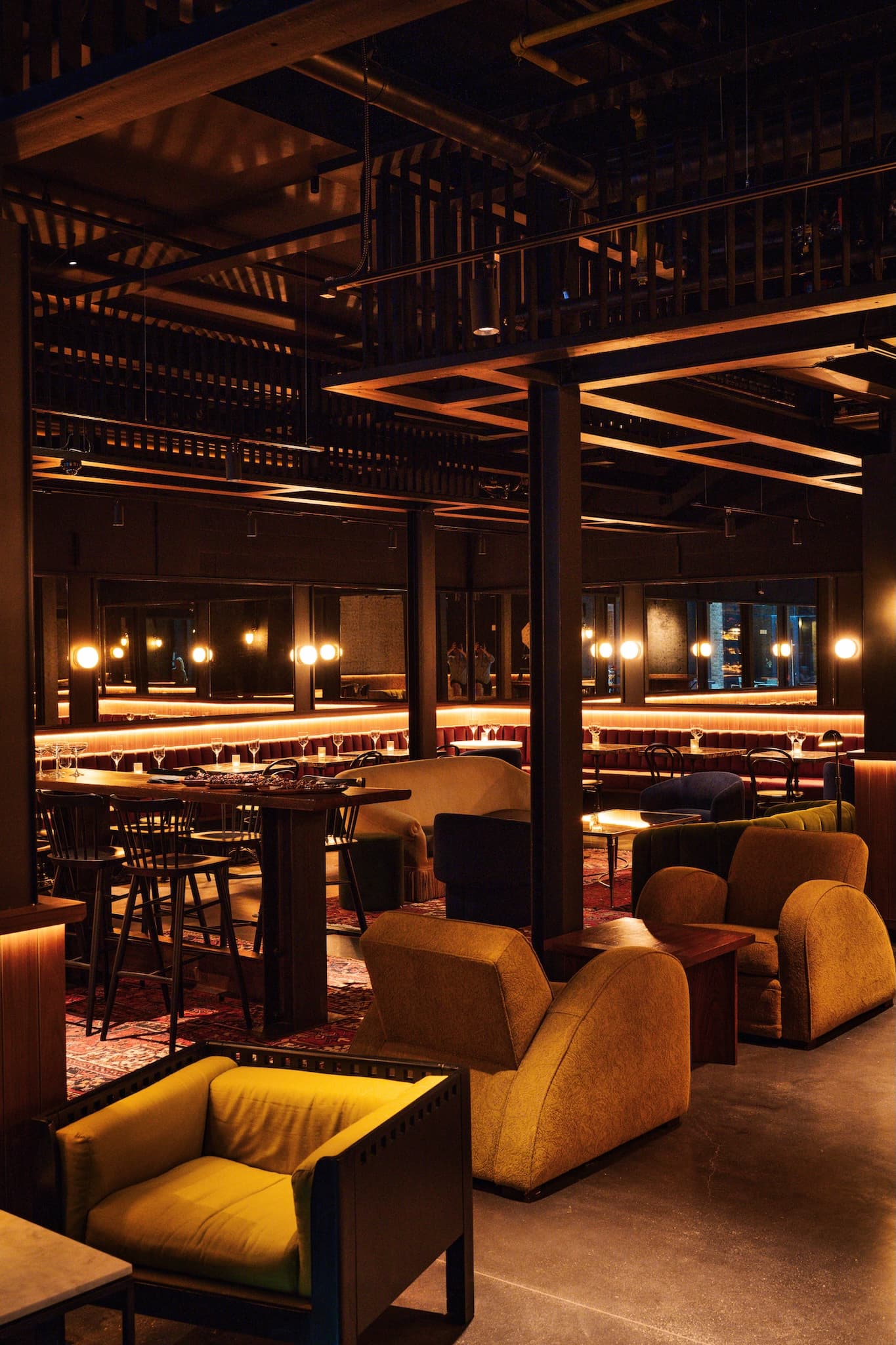 Comfortable mustard coloured chairs and leather banquette seating in the annex.