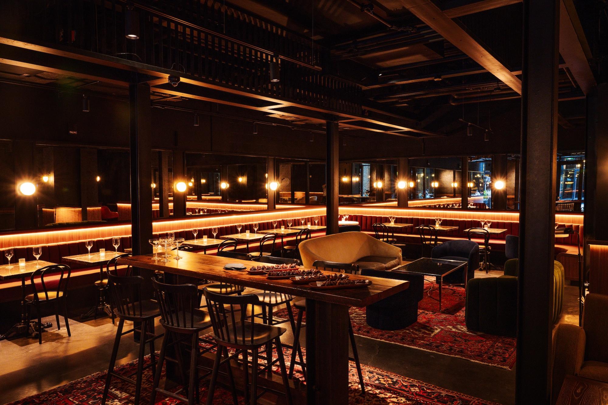 Leather banquette seating with small marble topped tables and comfortable chairs in the east annex lounge at the food hall.