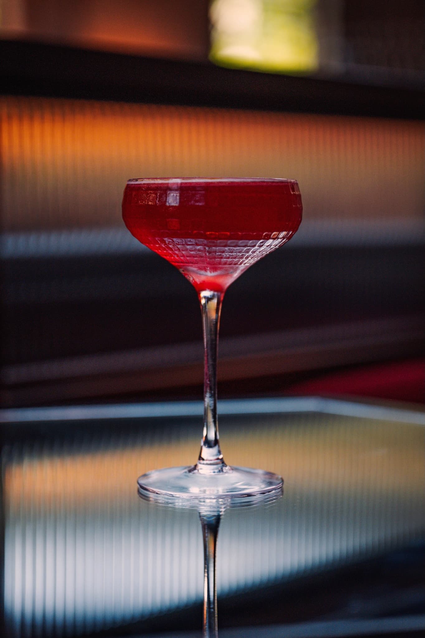 Red coloured cocktail in an elegant glass