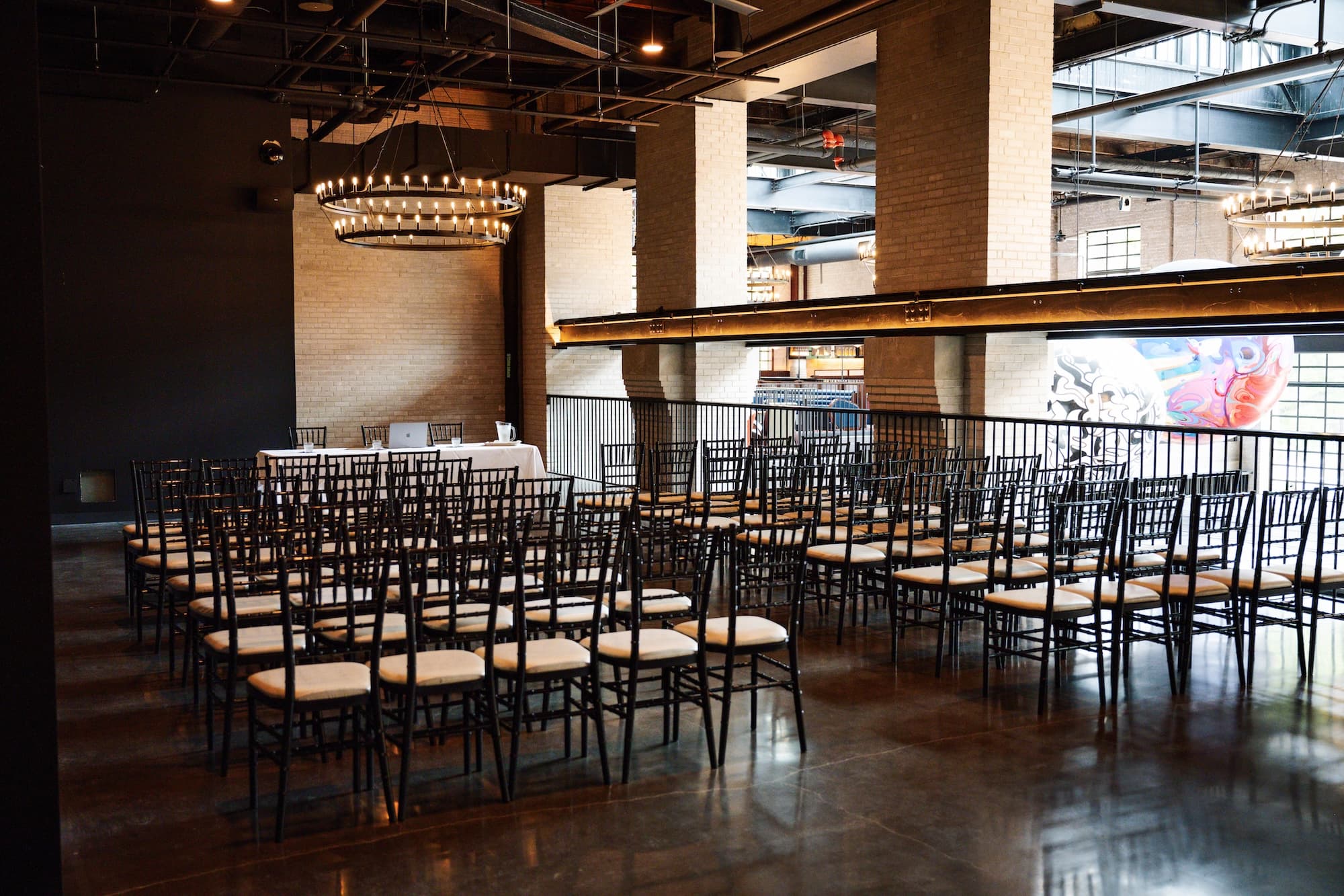 East Hall event space set up for a meeting with two rows of chairs and a speaker table at the front of the room