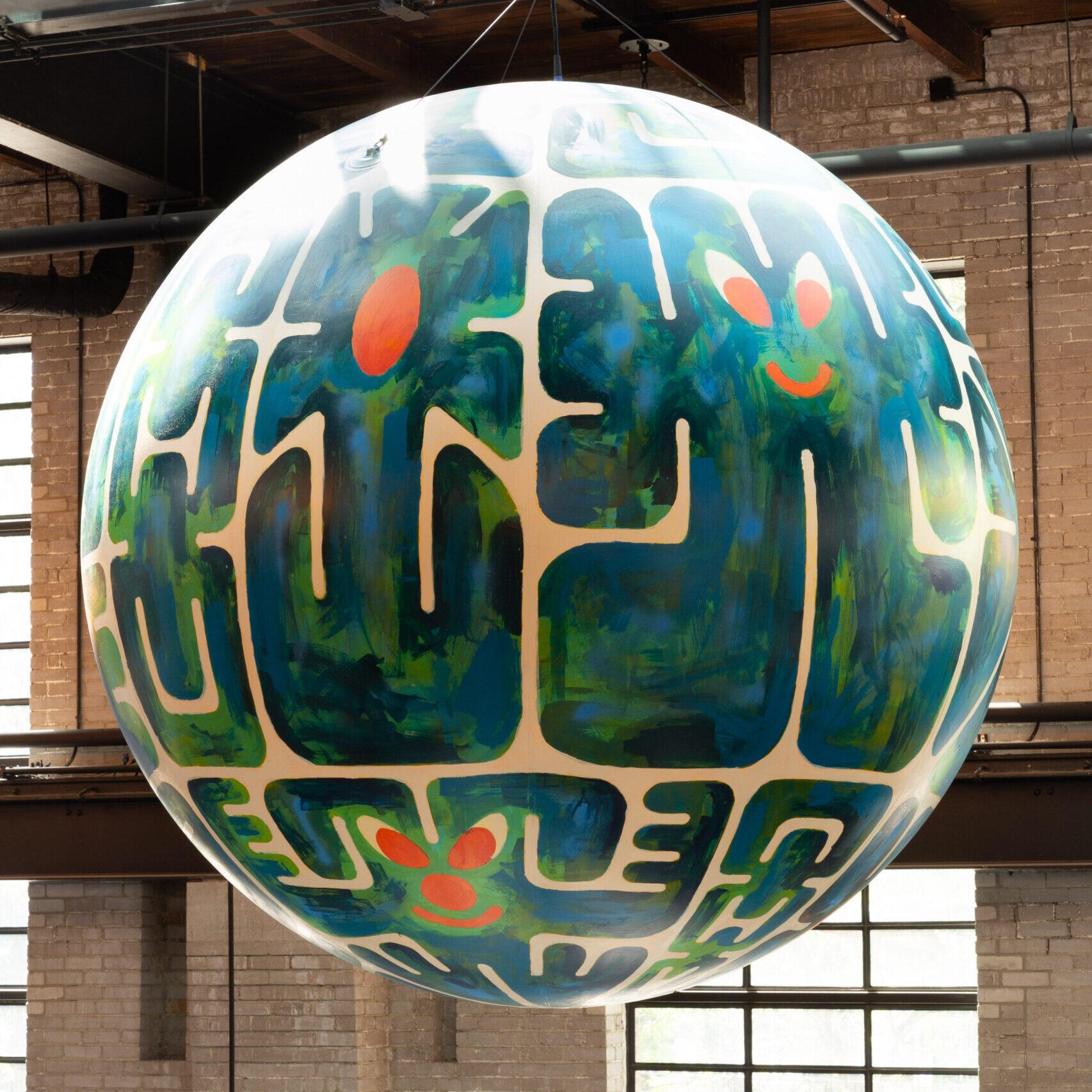 A colourful painted globe, of green and blue graffiti, hangs from the rafters of the food hall.