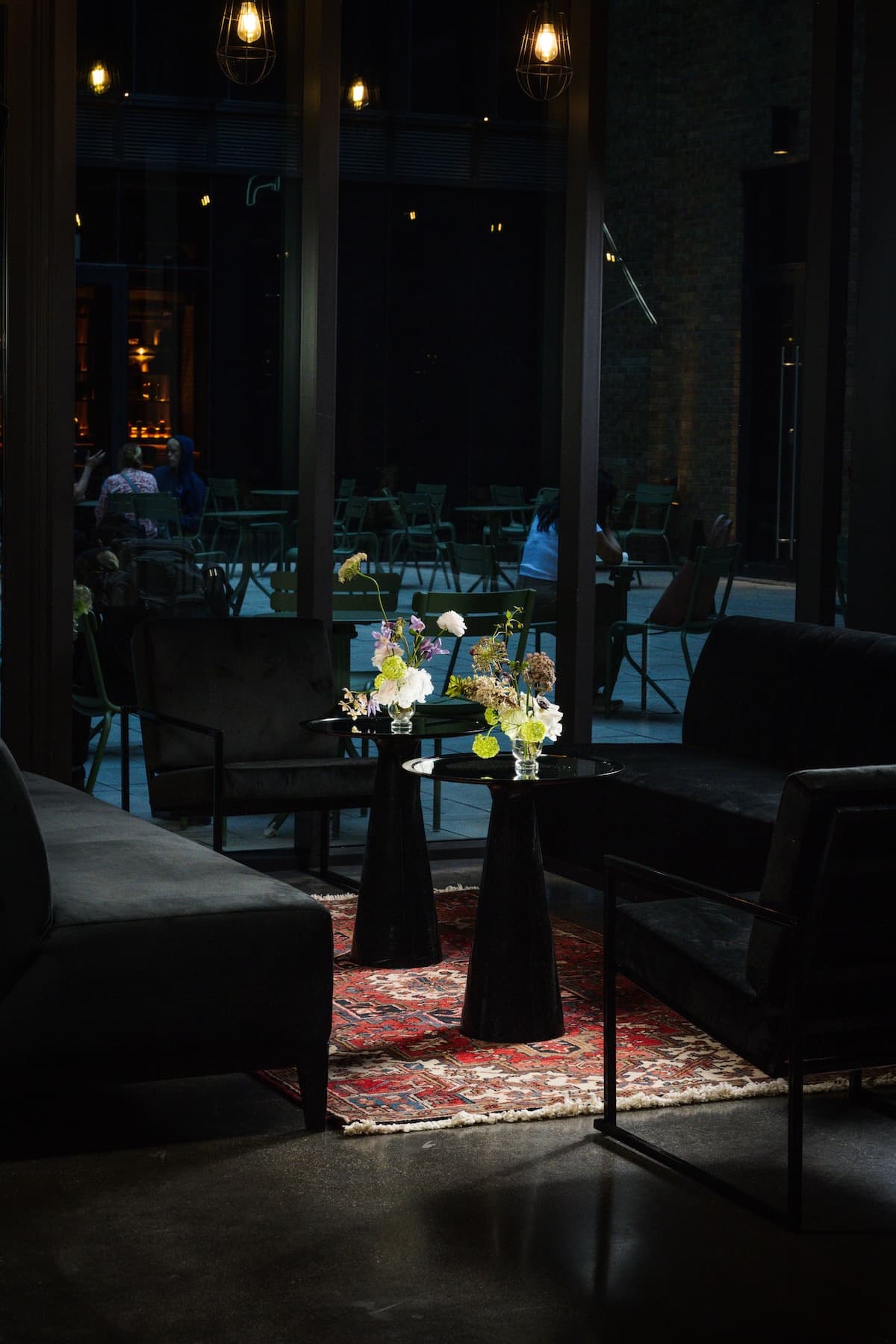 Event set up showing two black side tables and two couches.