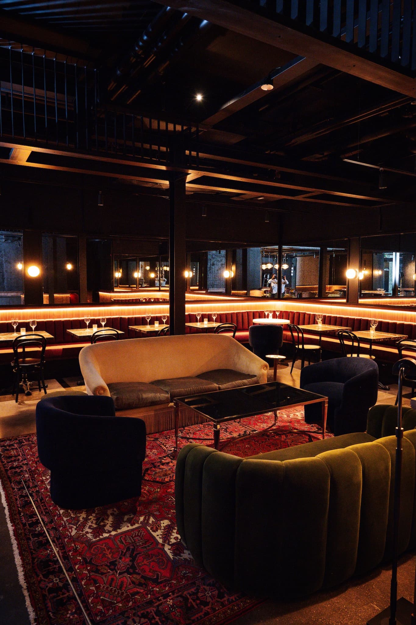 Art-deco velevet couches and chairs sitting on a red Persian carpet